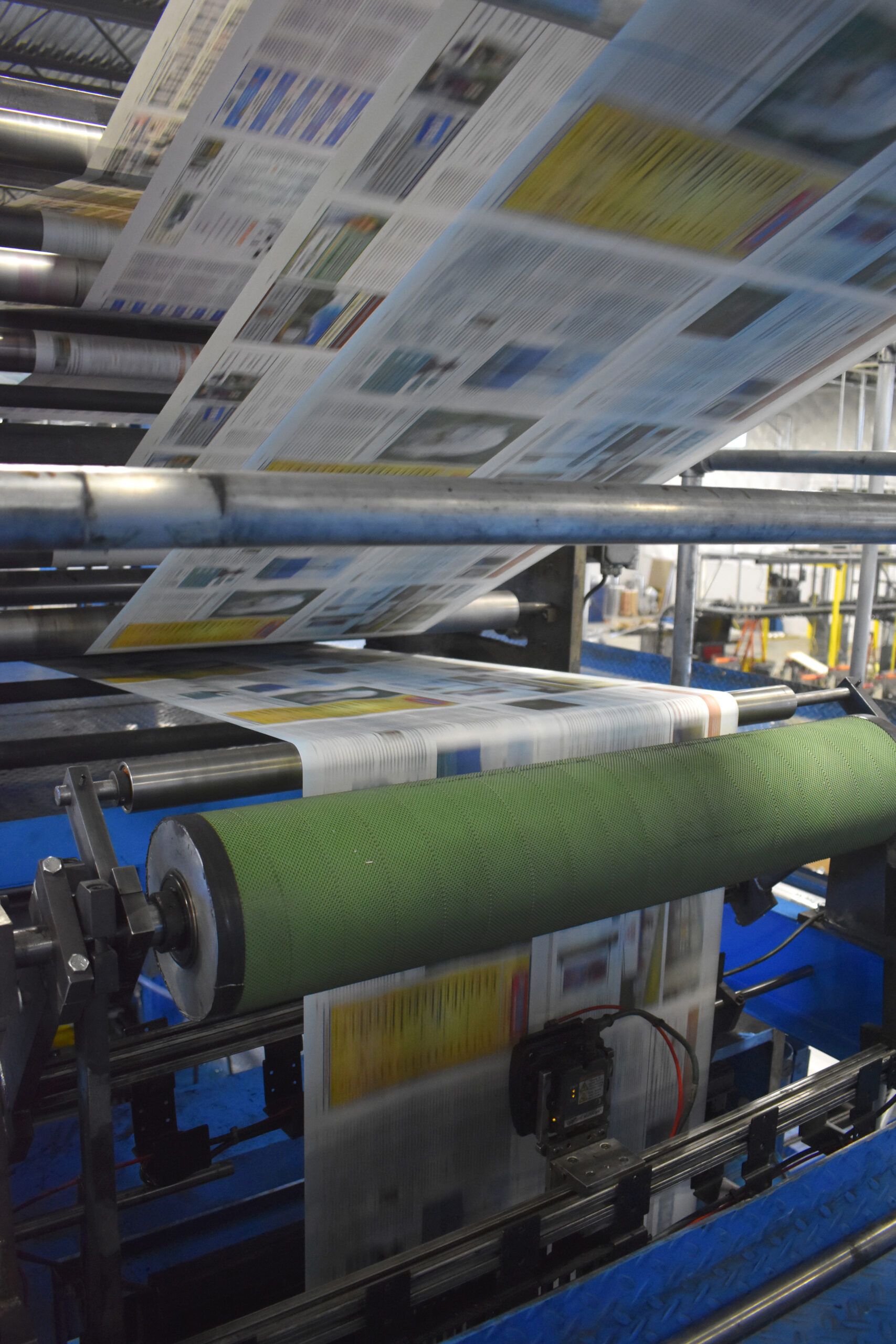 Layers of paper running through the web press