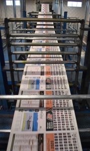 Top view of paper running through the web press
